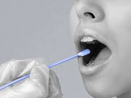 Person performing mouth swab test in clinic.